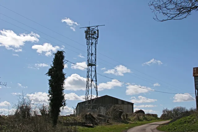 Antenna mast beside a farm building